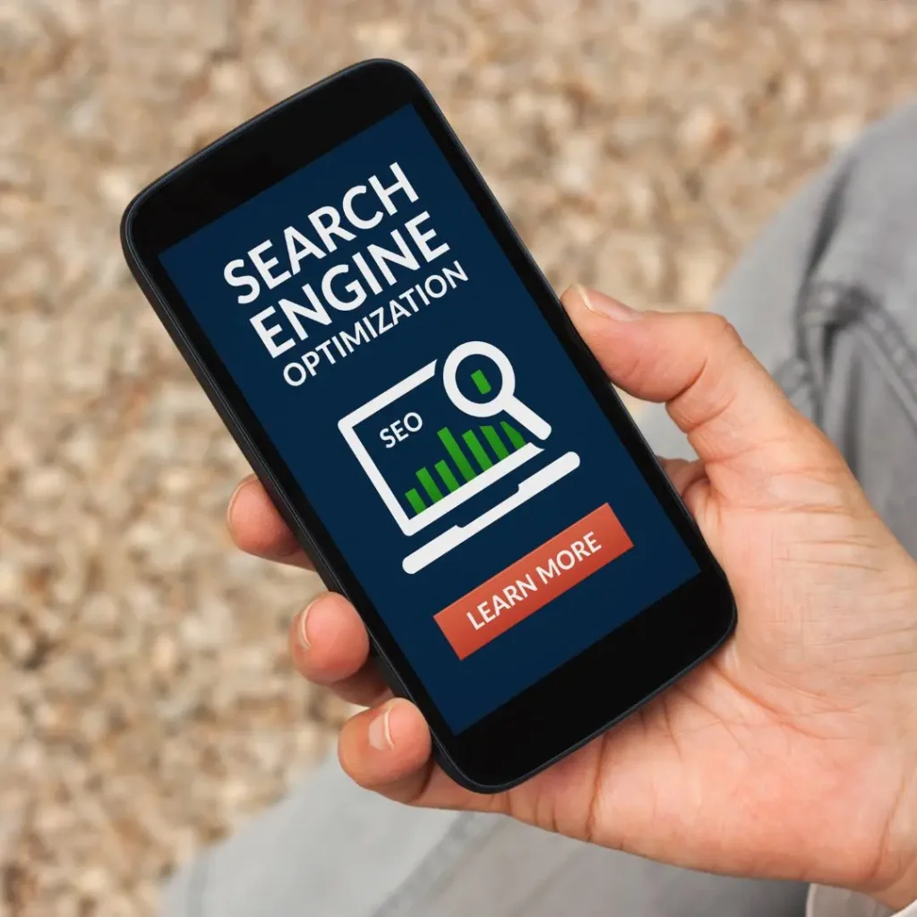 Mobile phone displaying a search engine optimization (SEO) graphic with a call to action to learn more